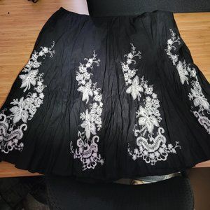 Black broomstick knee length skirt with white embroidery